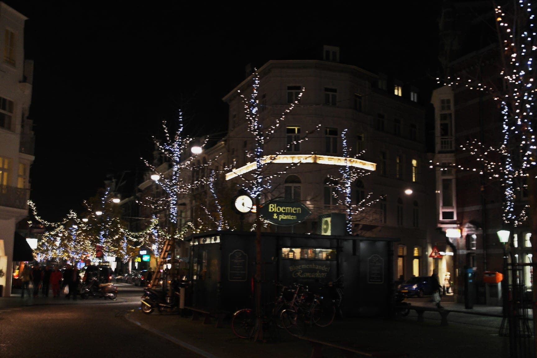 Trees wrapped in white lights line Wycker Brugstraat in the Wyck quarter of Maastricht at night.