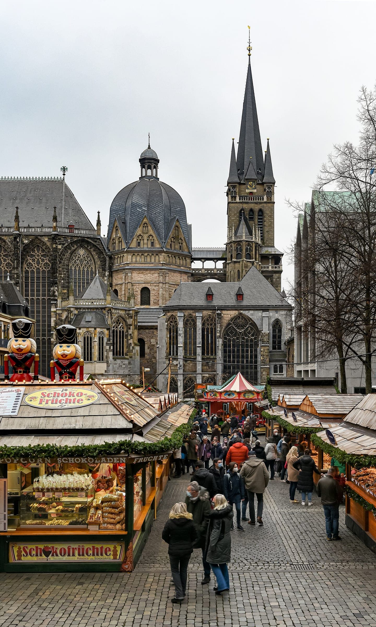 Market stalls lead across the Katschhof towards the dome and tower of Aachen Cathedral