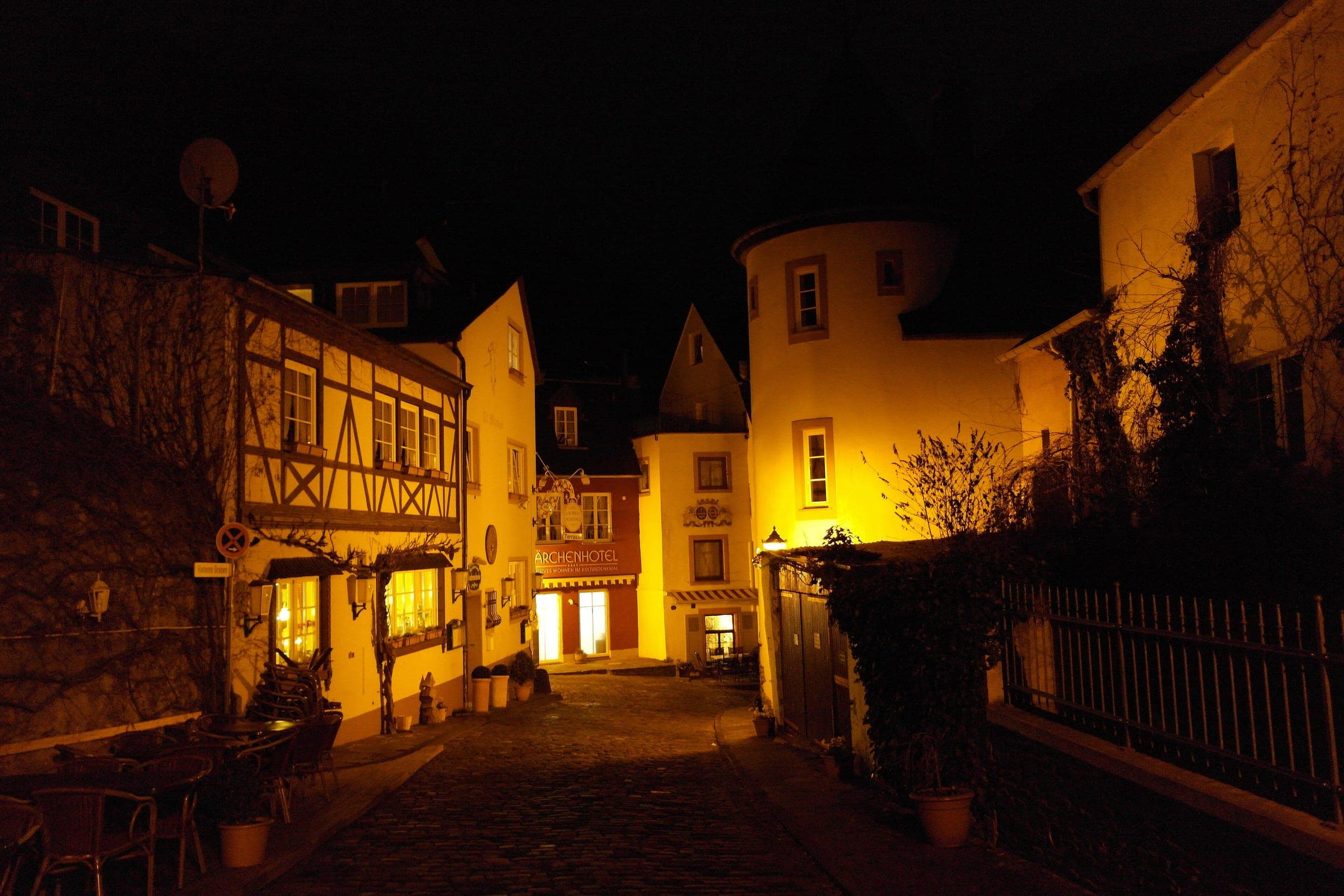 A cobbled lane in Bernkastel's old town glows under warm lamplight at night