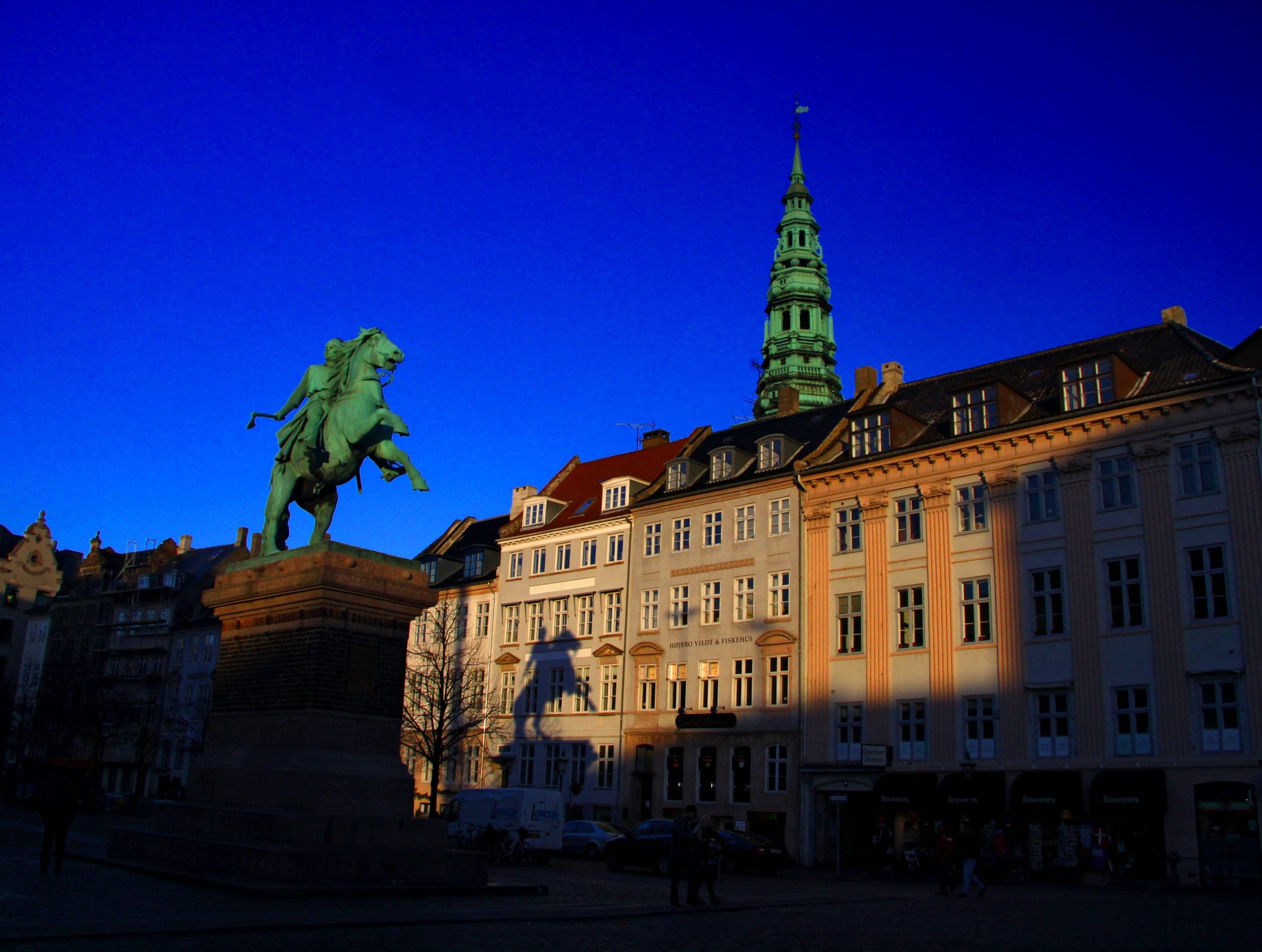Low January sun lights the house fronts of Højbro Plads in Copenhagen behind the statue of Absalon.