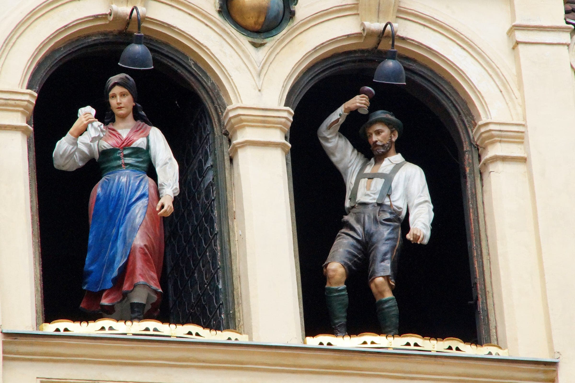 The carved couple in Styrian dress dance out of the Glockenspiel windows above Glockenspielplatz in Graz.