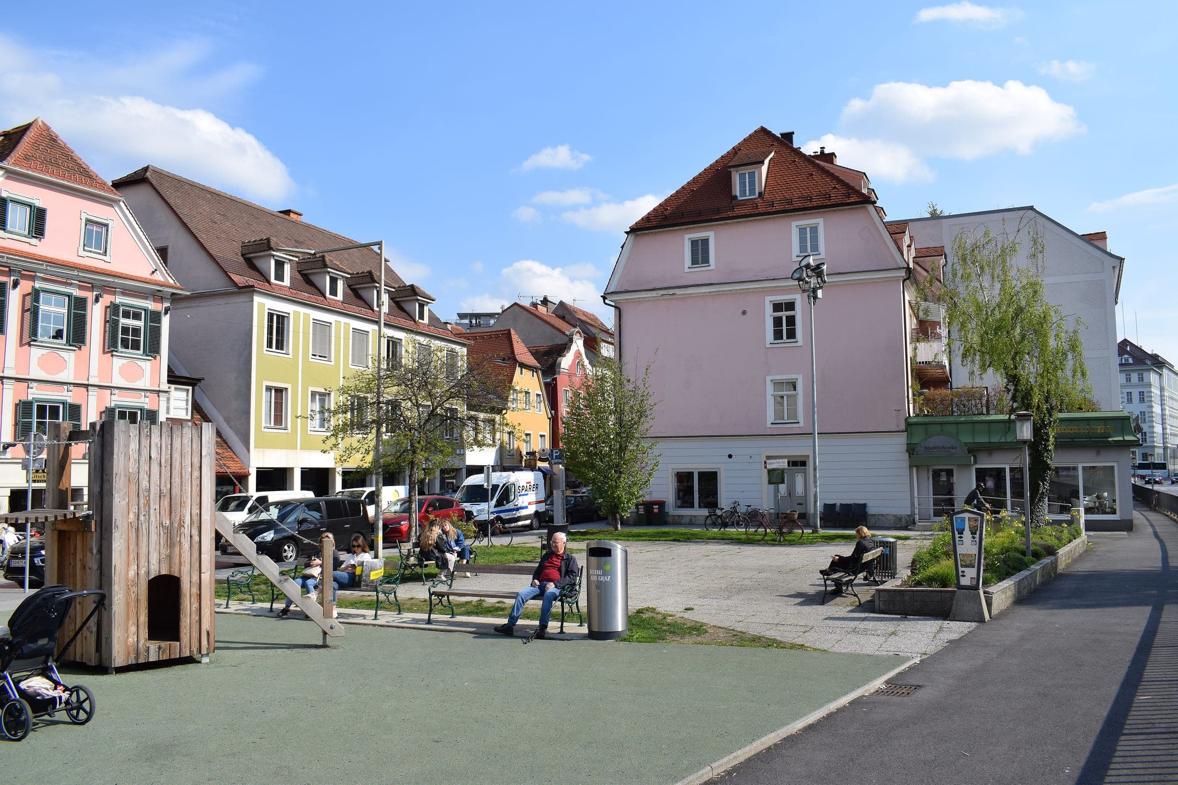 Pastel houses and a small playground border Kapistran-Pieller-Platz beside the Franciscan quarter in Graz.