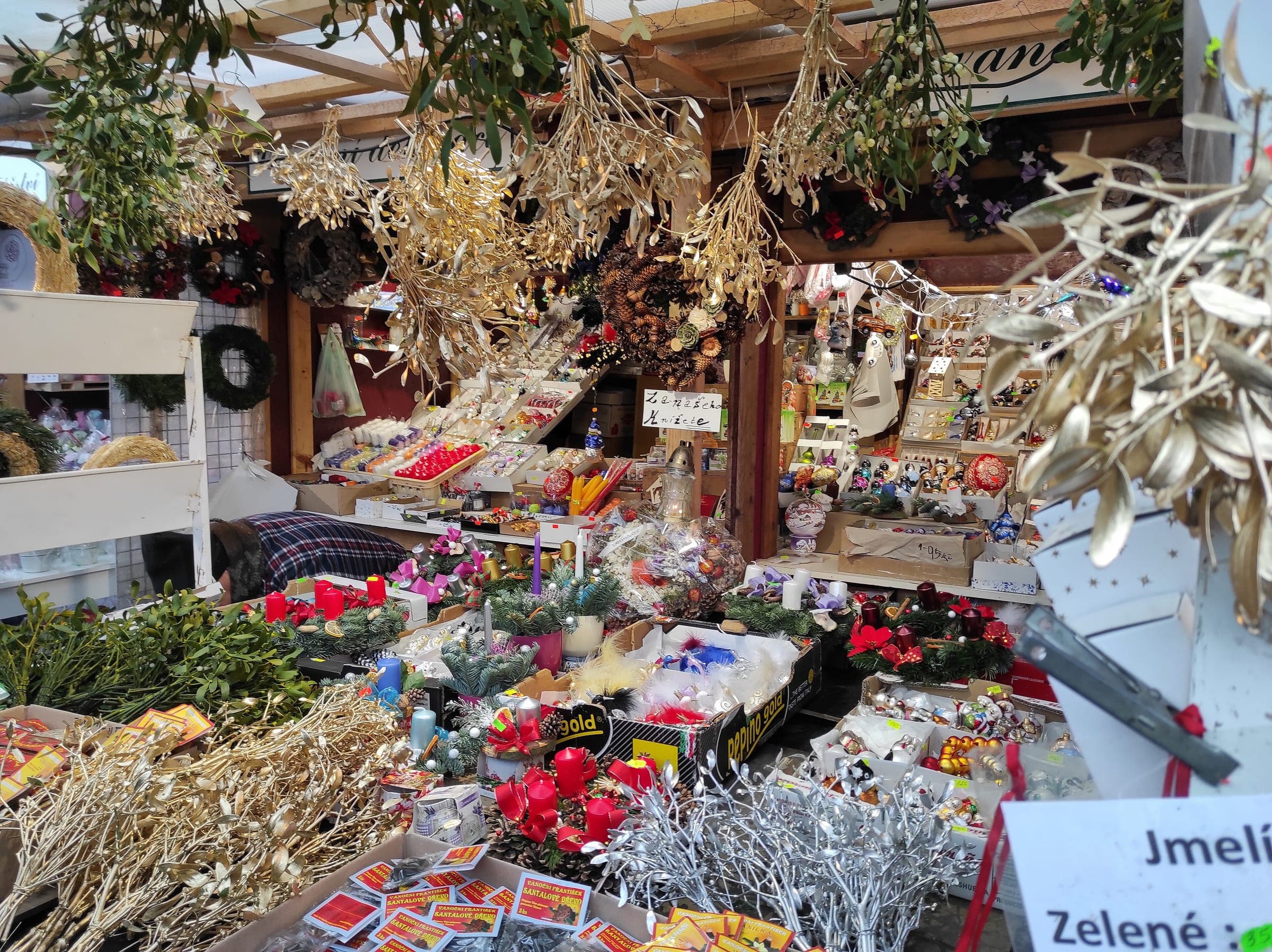 Dried flowers and straw ornaments crowd a stall at the náměstí Míru Christmas market in Prague.