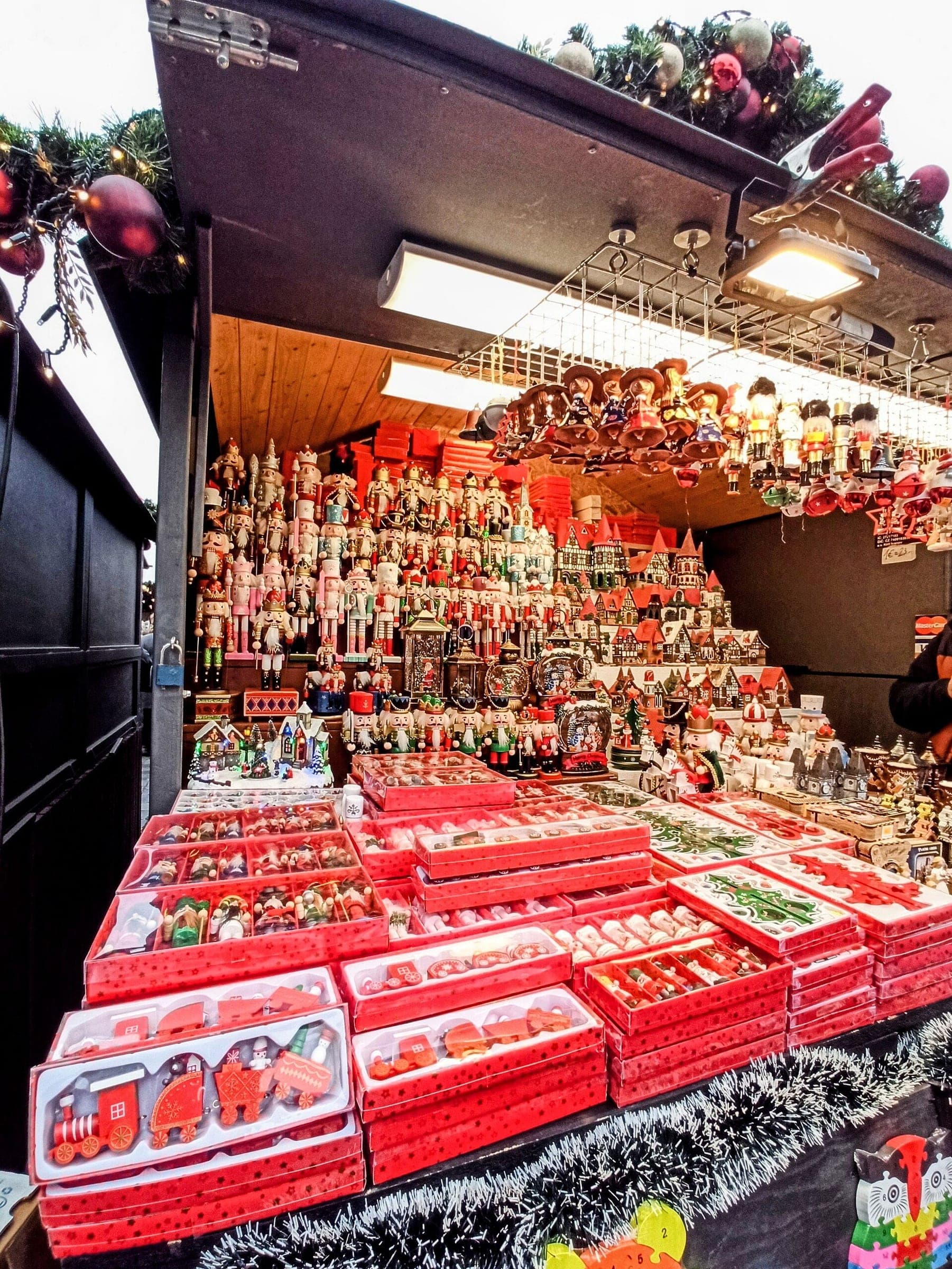 A stall on Old Town Square in Prague sells wooden nutcrackers and painted toy trains.