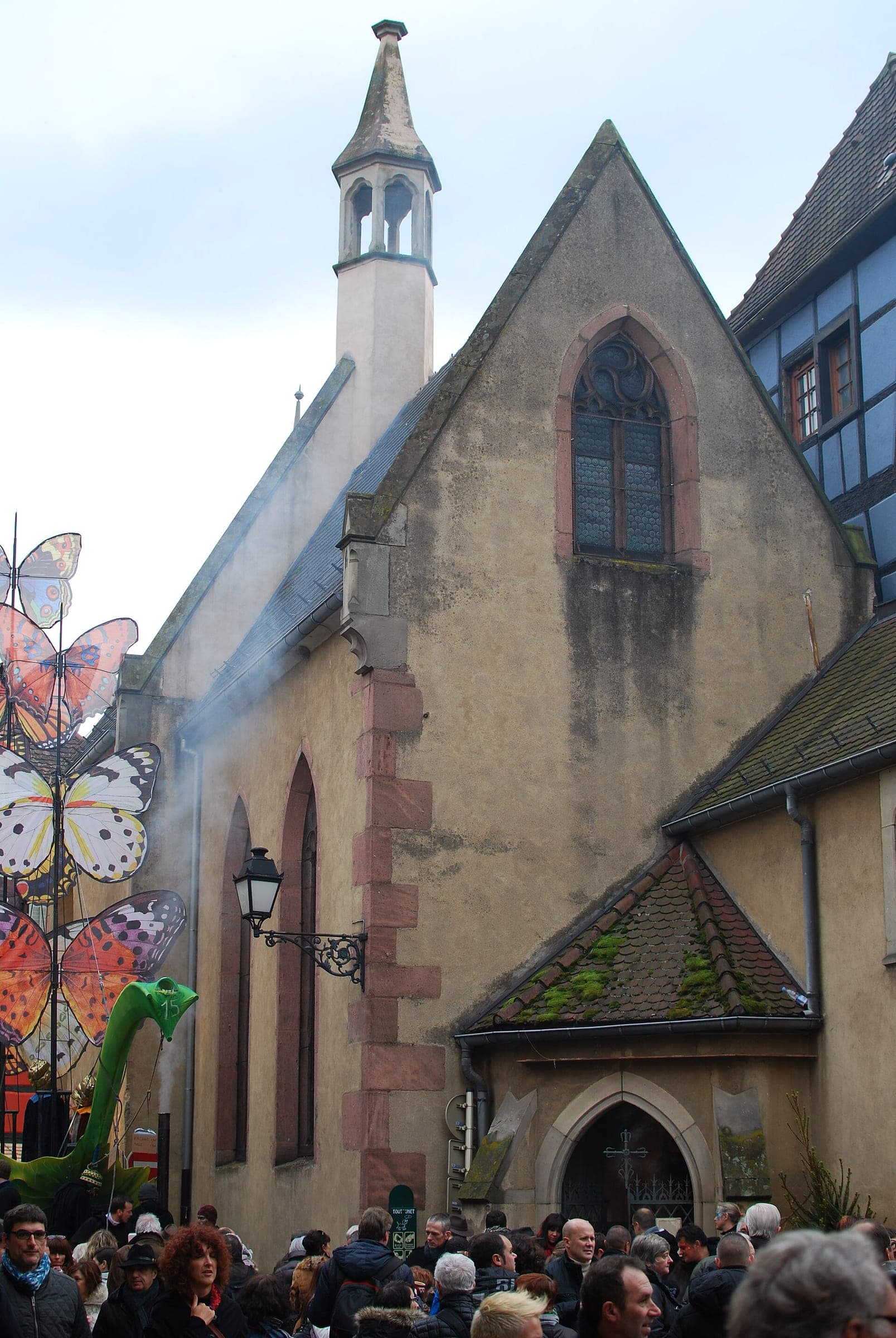 Crowds gather below the Sainte-Catherine chapel during the medieval Christmas market in Ribeauvillé.