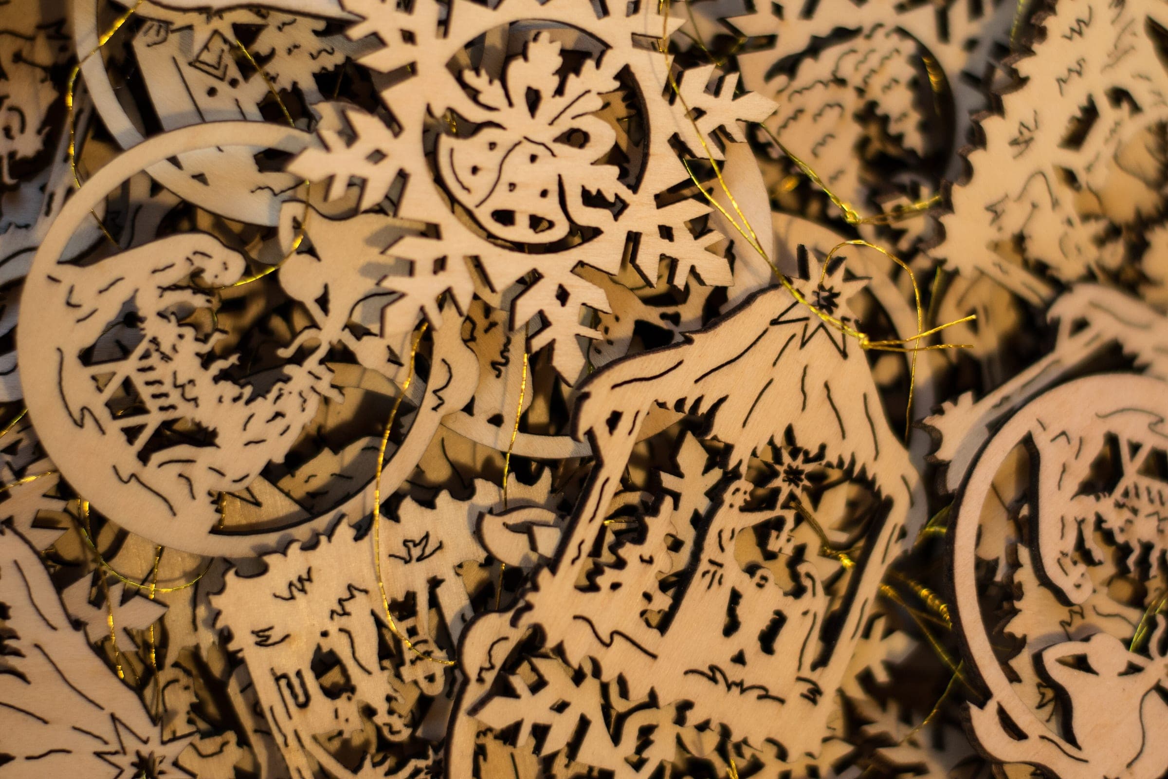 Cut wooden ornaments of stars and snowflakes lie piled on a stall at the Riquewihr Christmas market.