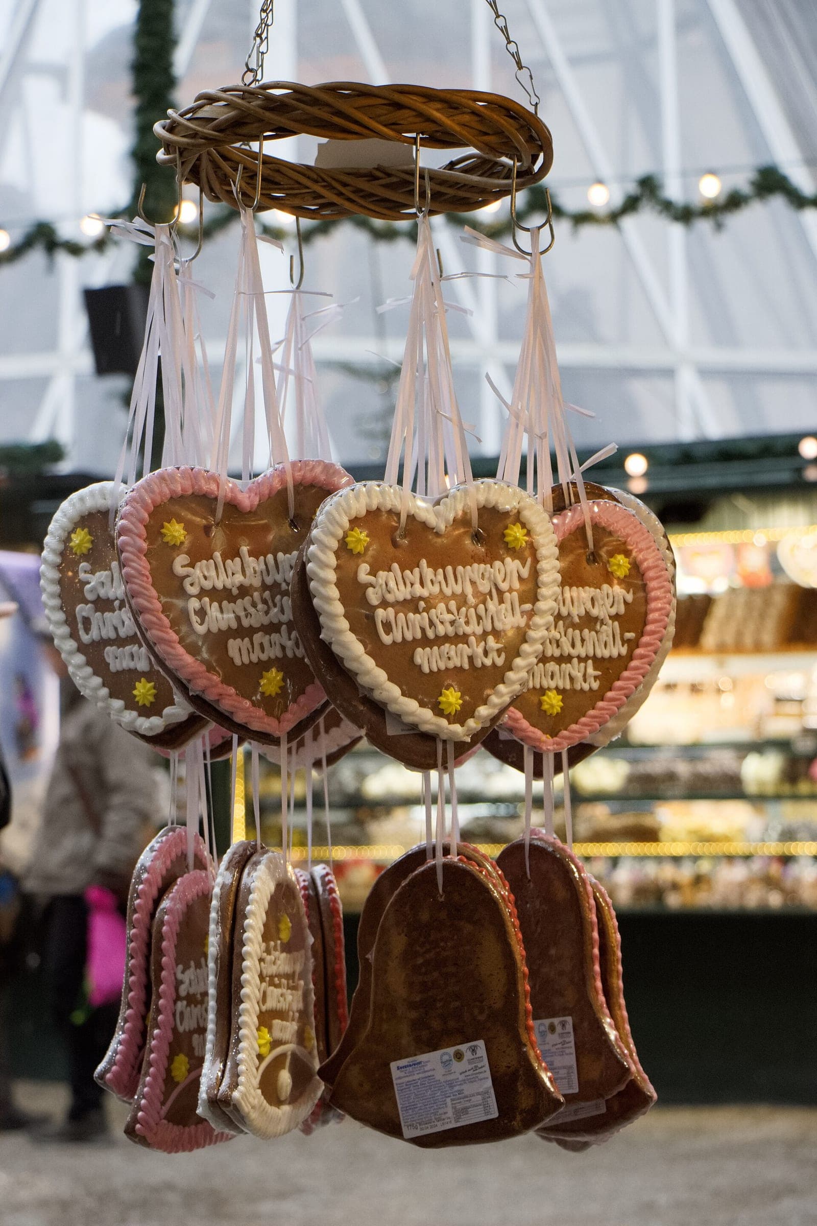 Gingerbread hearts iced with Salzburger Christkindlmarkt hang from a stall on the Domplatz