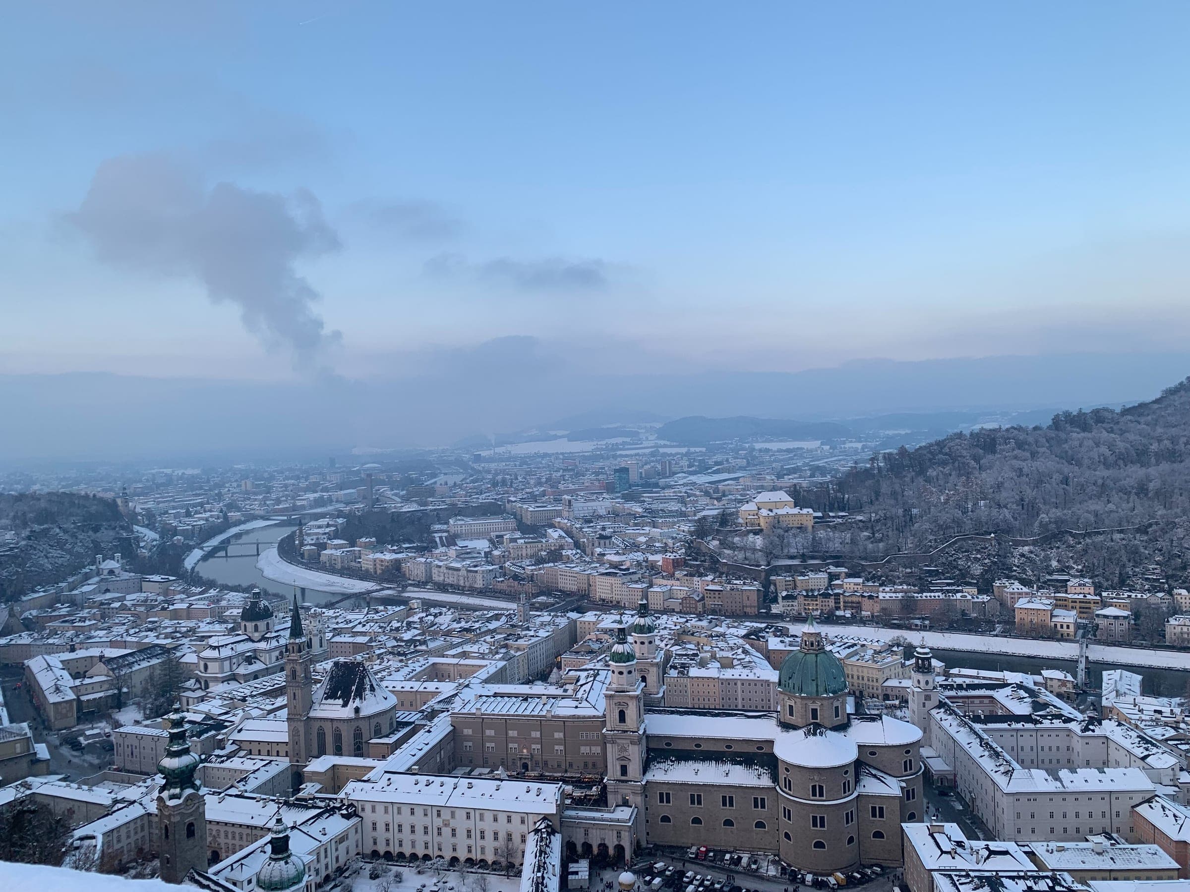 Snow covers the roofs of Salzburg's old town and cathedral in the view from Hohensalzburg Fortress