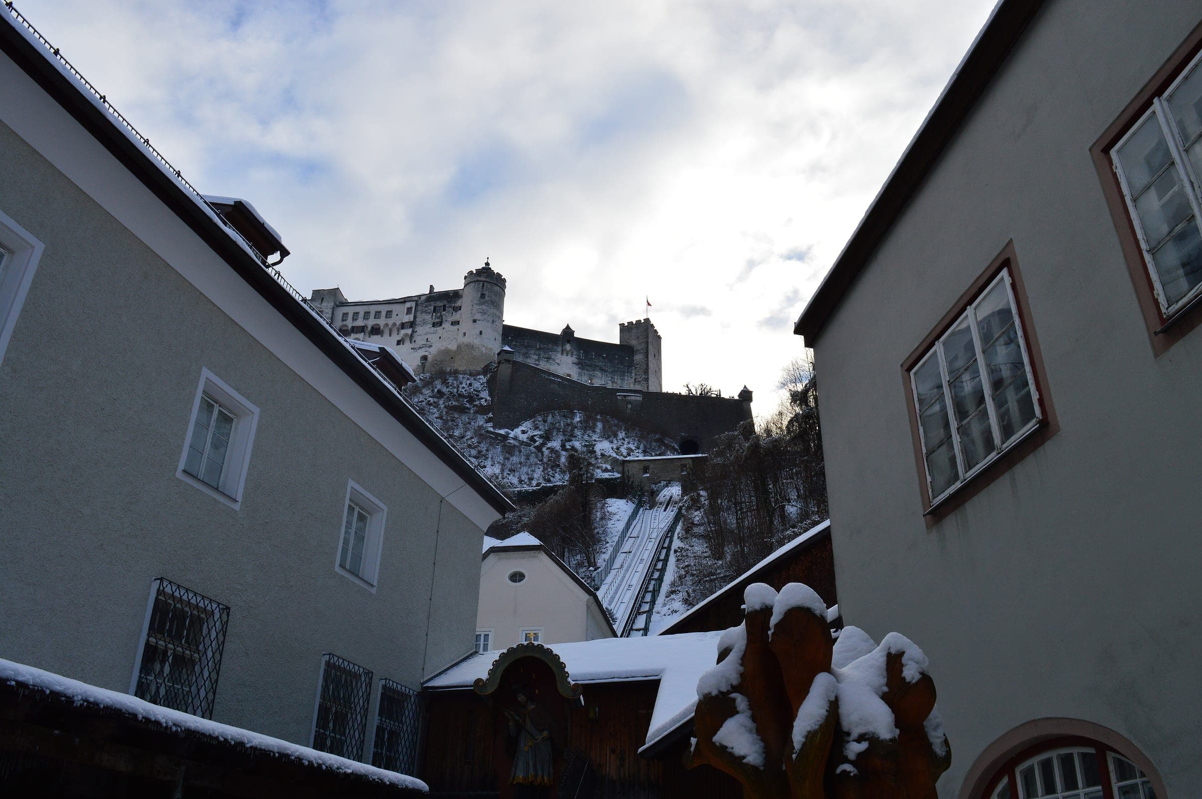 The Festungsbahn funicular track runs up a snowy slope to Hohensalzburg Fortress in Salzburg