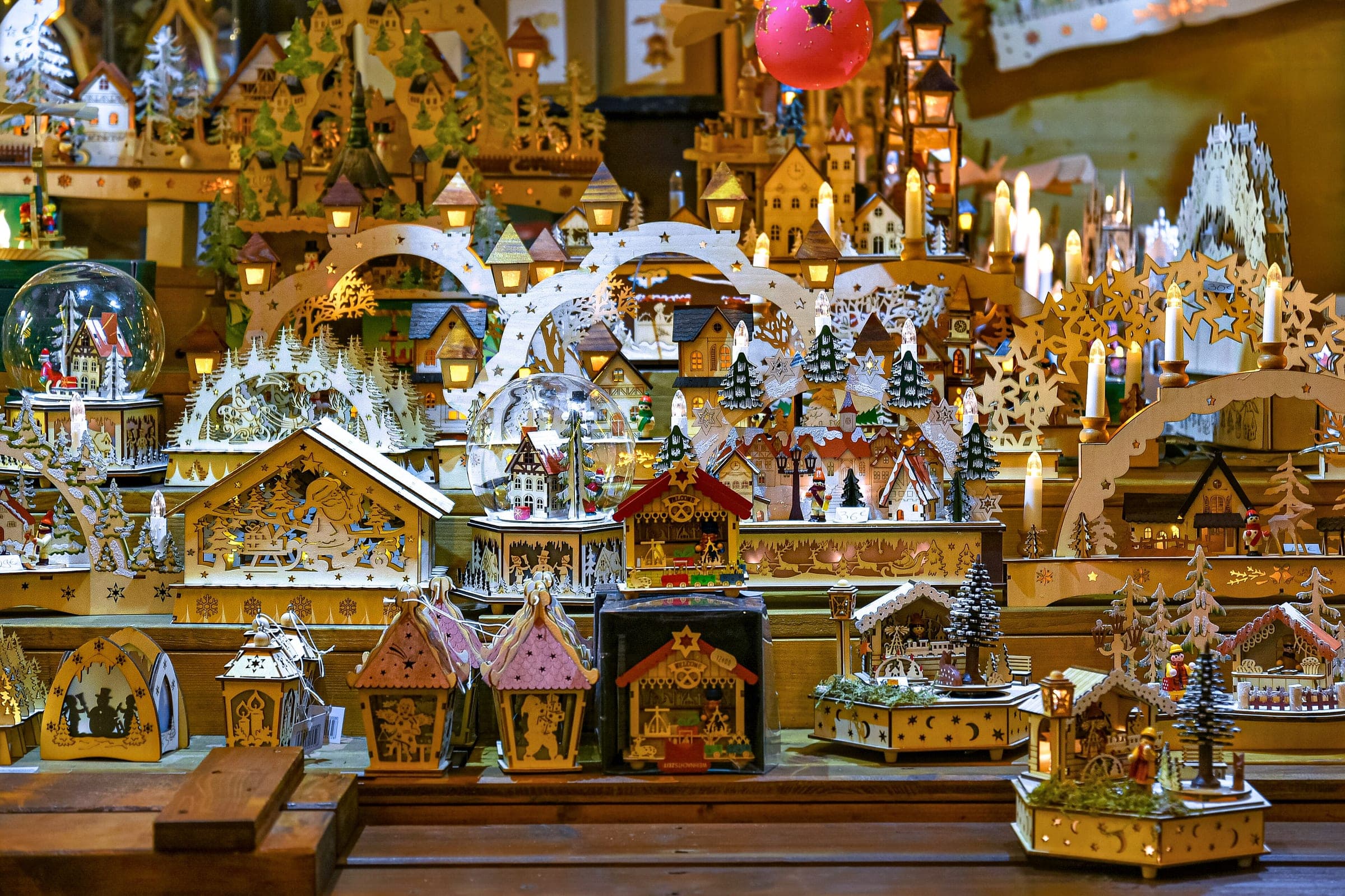 Carved wooden houses, arches and candle holders fill a craft stall at the cathedral market in Strasbourg.