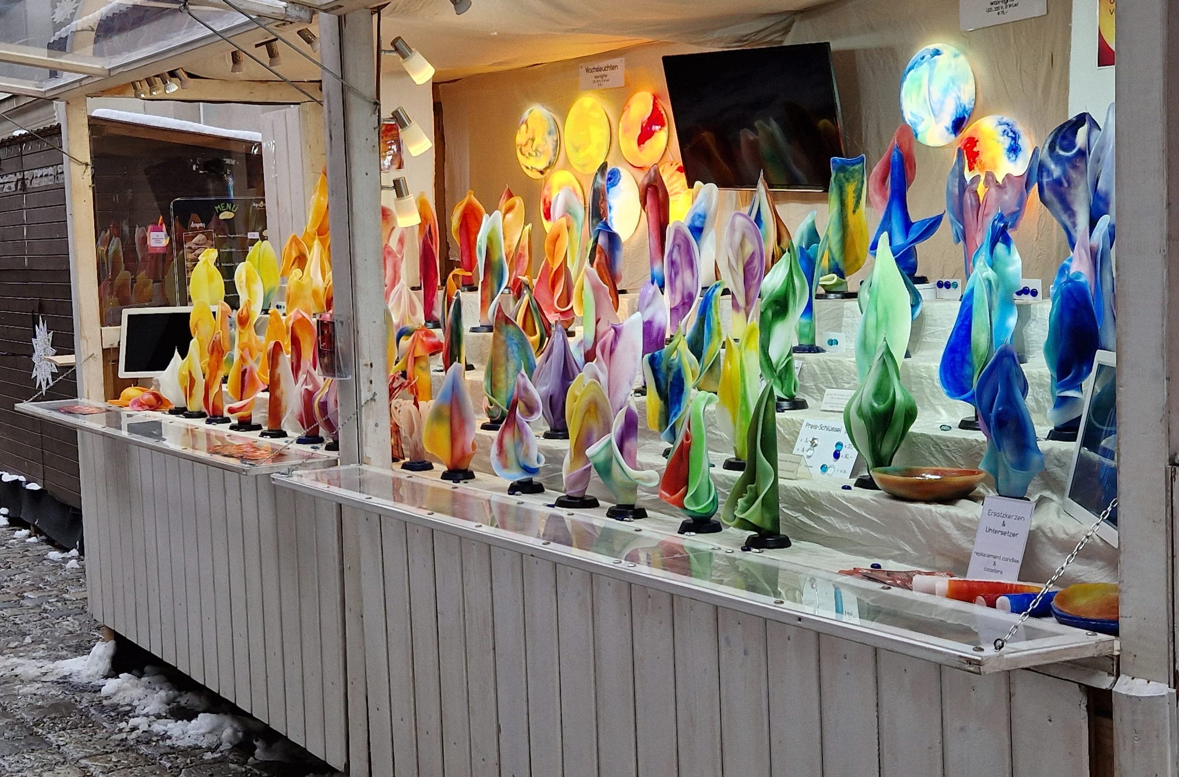 Bright blown glass figures fill the shelves of a craft stall at the Spittelberg Christmas market in Vienna.