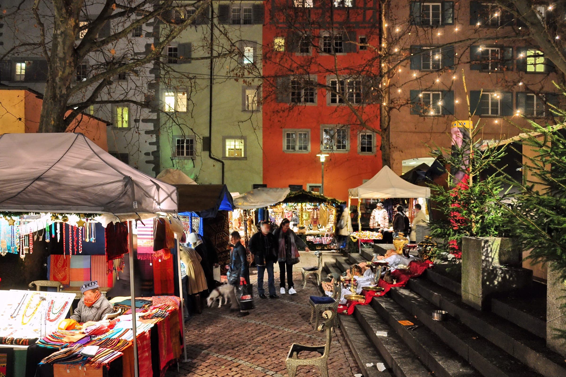 Stalls and fairy lights fill the Rosenhof in Zurich's Niederdorf as the Christmas market opens at dusk