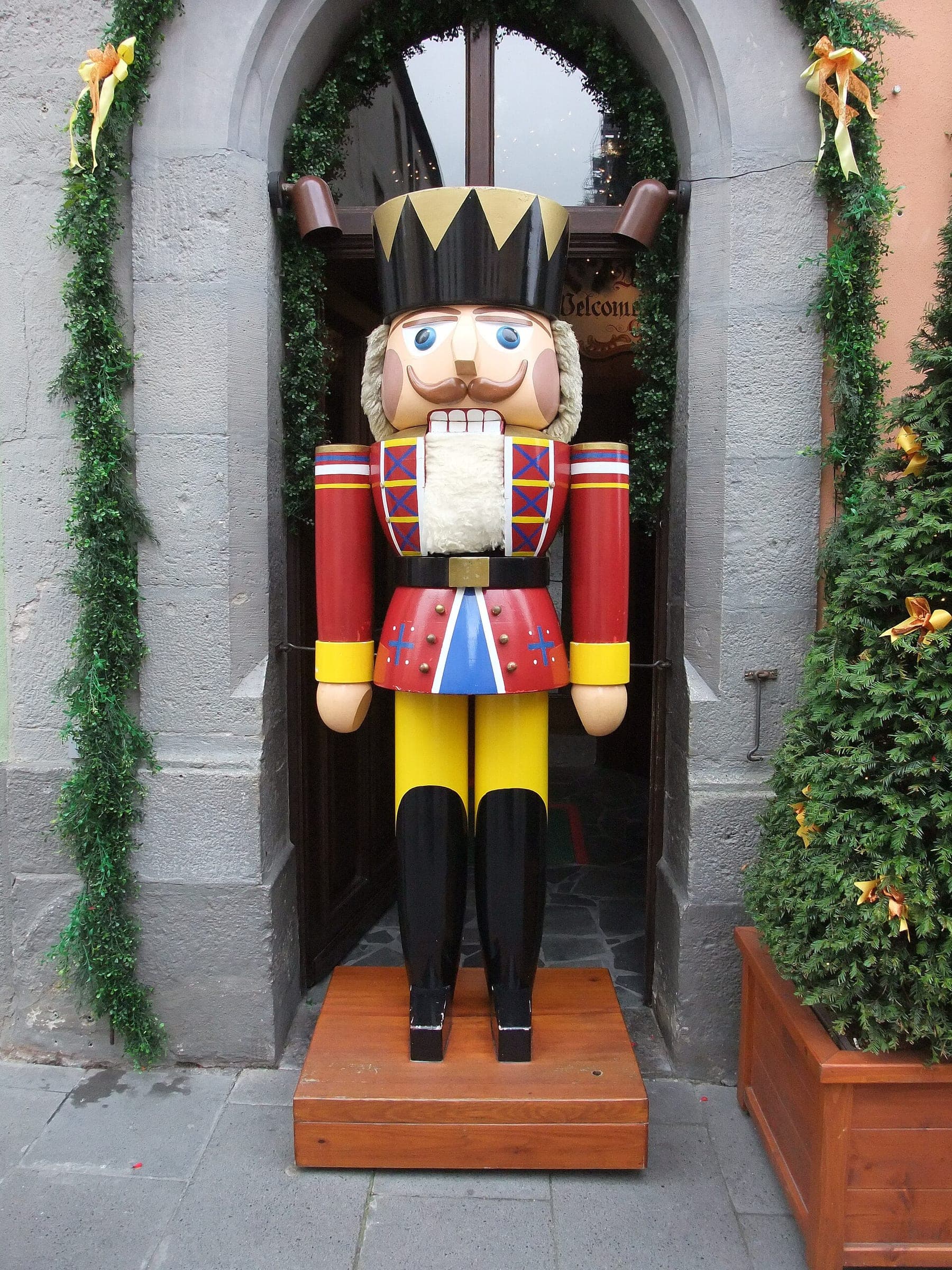 A life-size wooden nutcracker guards the garlanded doorway of the German Christmas Museum in Rothenburg.