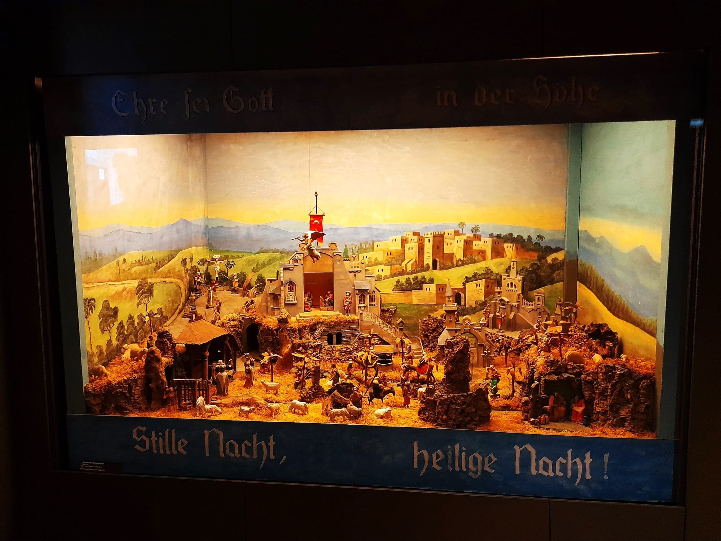 A lit Christmas mountain diorama of Bethlehem glows in a gallery of the Manufaktur der Träume in Annaberg-Buchholz.