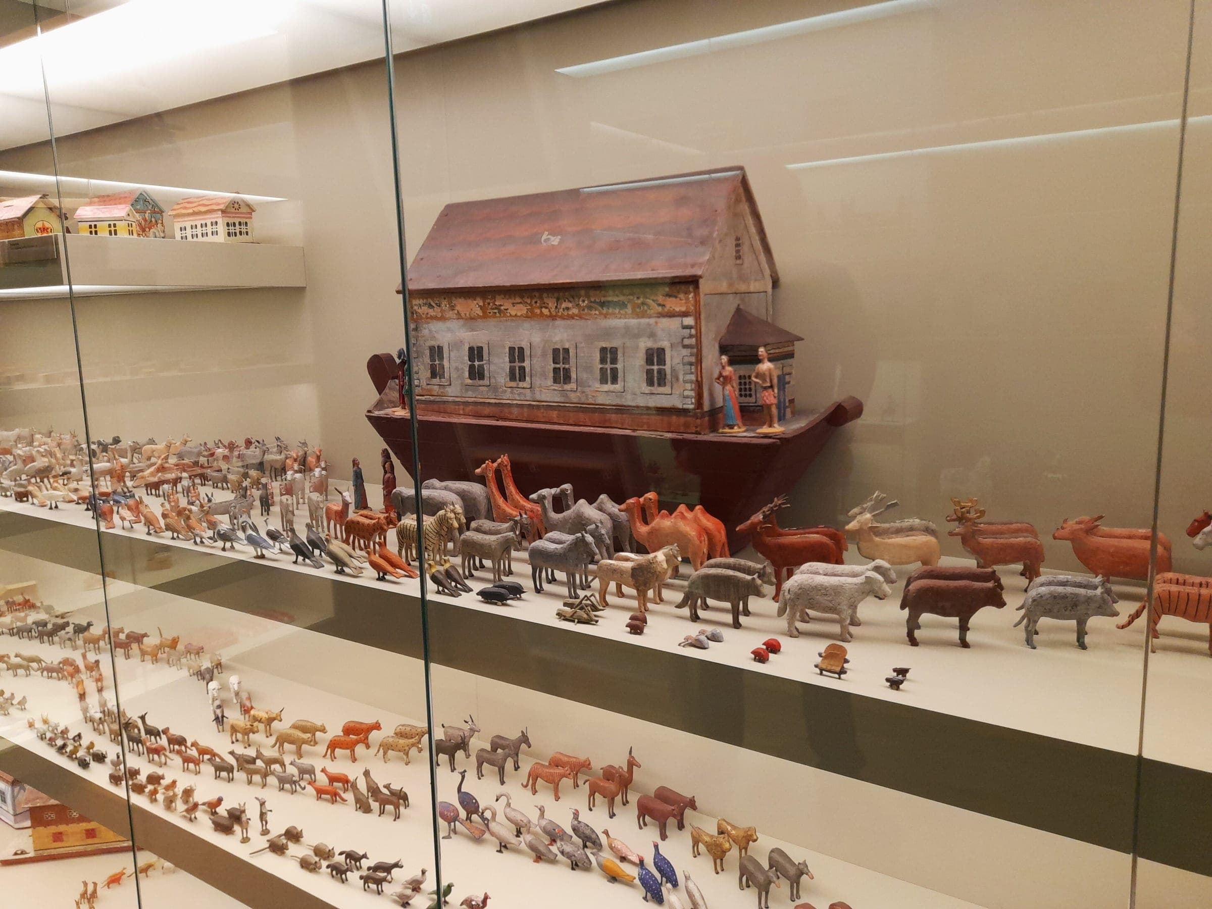 A toy Noah's ark and rows of turned wooden animals fill a glass case in the Manufaktur der Träume in Annaberg-Buchholz.
