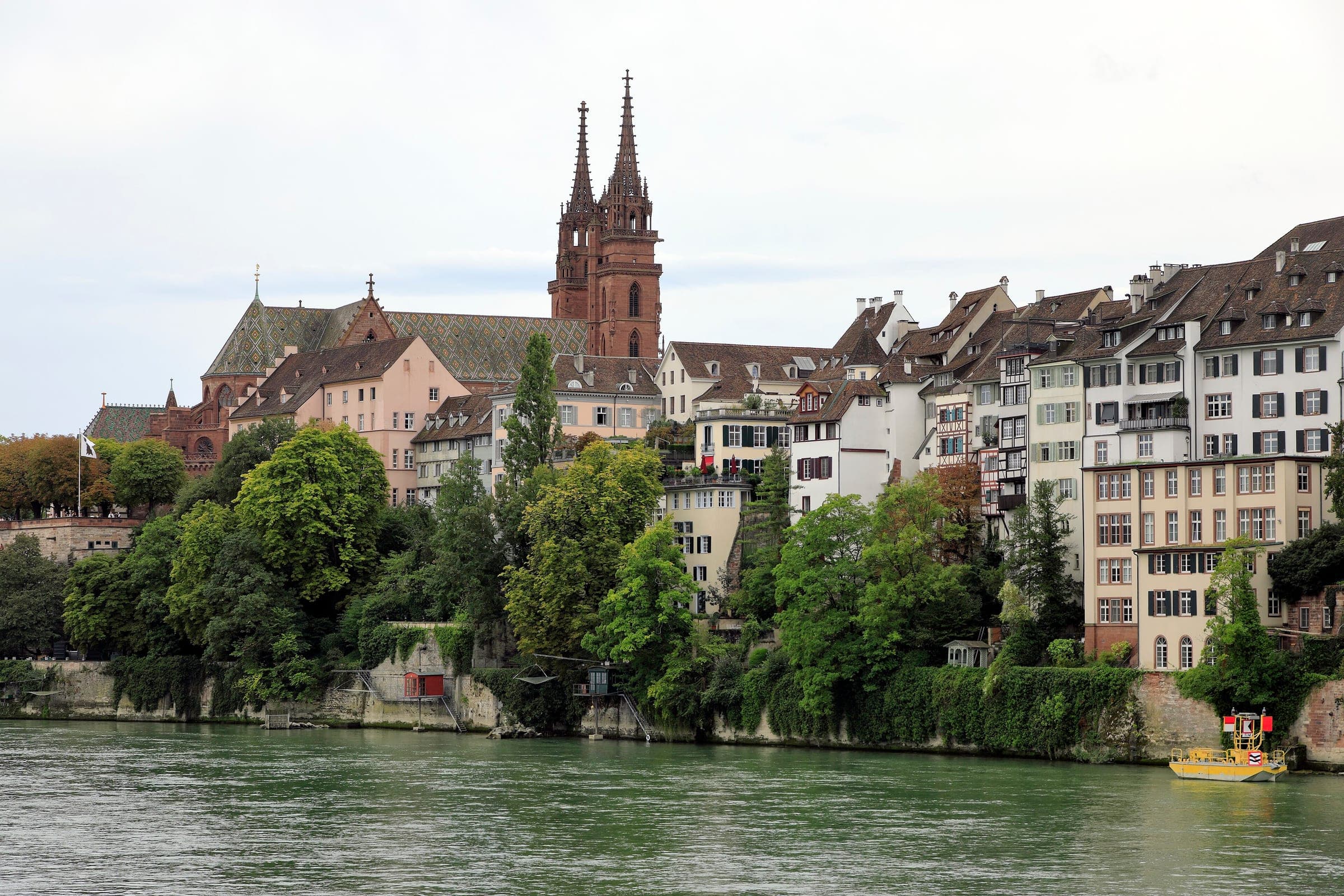 Old town houses climb from the Rhine to the twin towers of Basel Minster