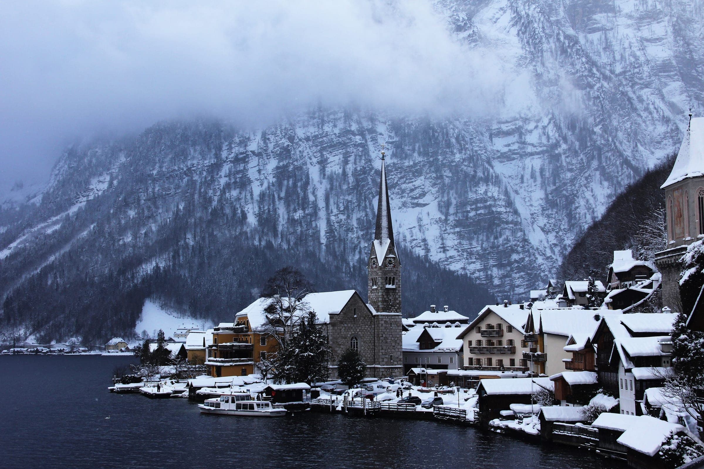 Fresh snow covers the roofs around Hallstatt's Protestant church on the shore of the Hallstätter See