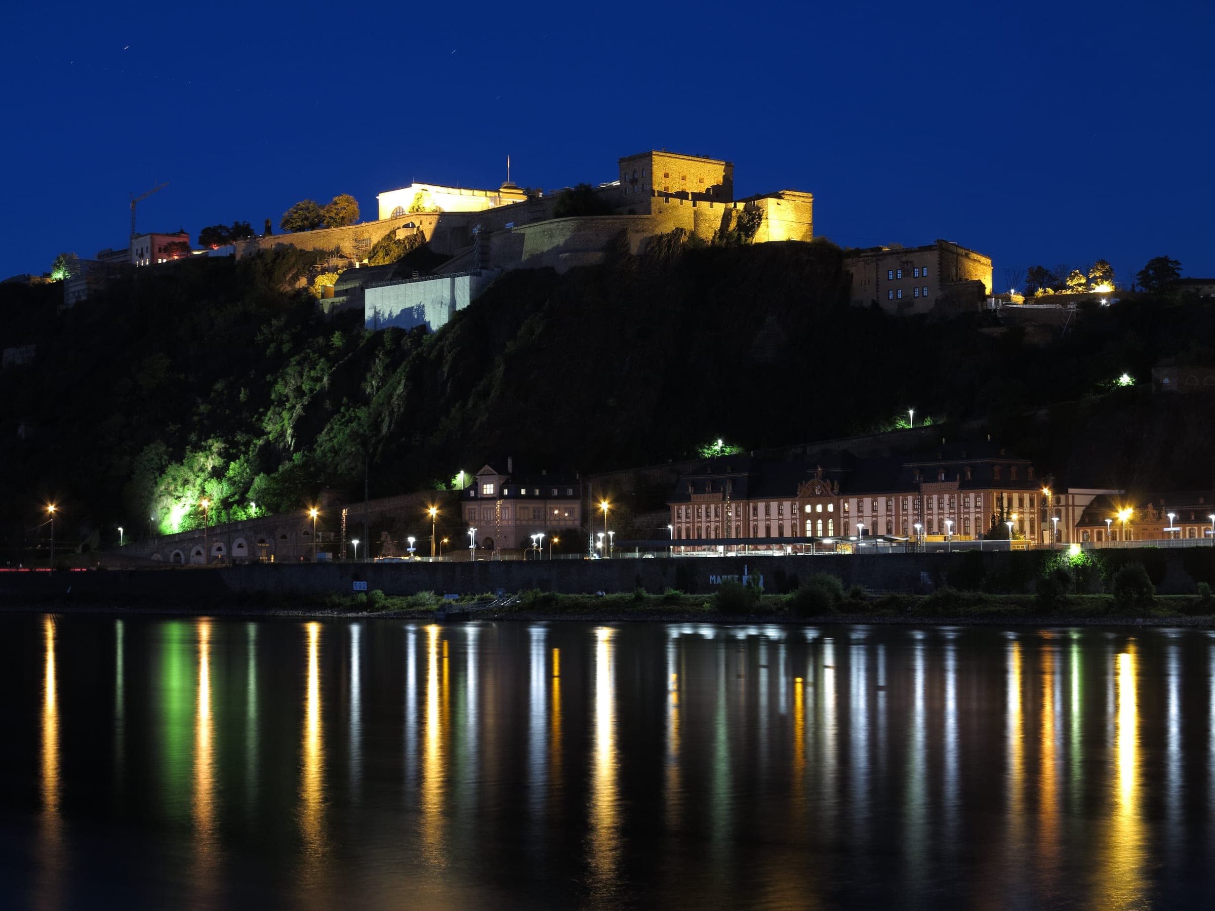 Ehrenbreitstein Fortress glows on its cliff above the Rhine at Koblenz at blue hour