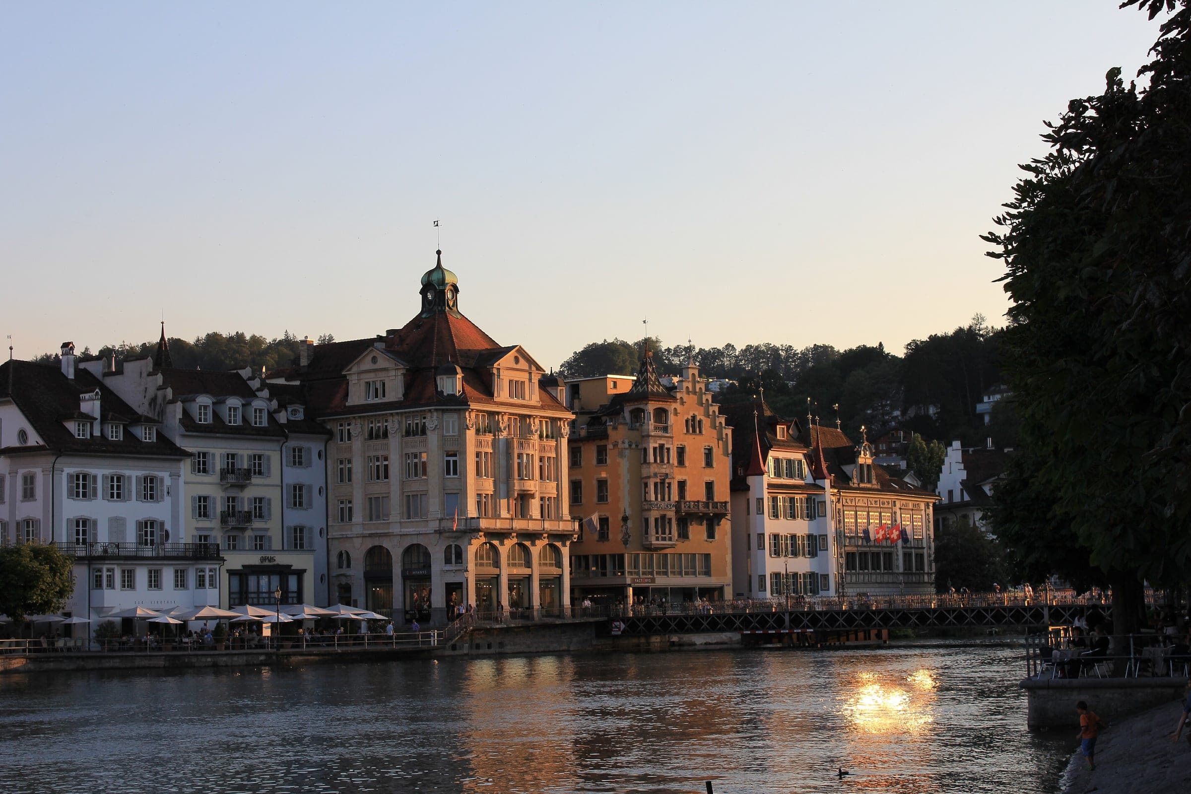 Evening sun lights the old town houses along the Reuss in Lucerne