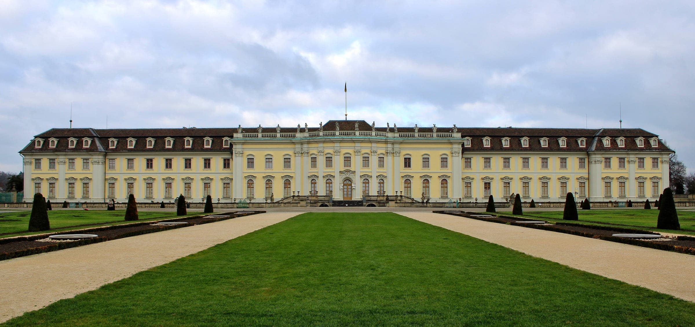 The long south front of Ludwigsburg Palace faces its trimmed garden lawns under a December sky.