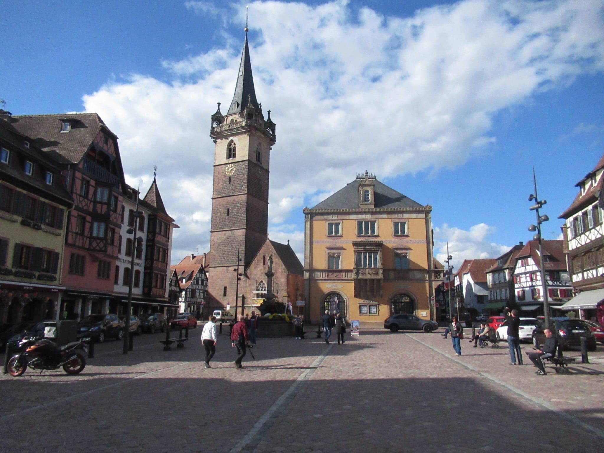 The Kapellturm bell tower rises over Place du Marché in Obernai, where the Christmas market sets up.