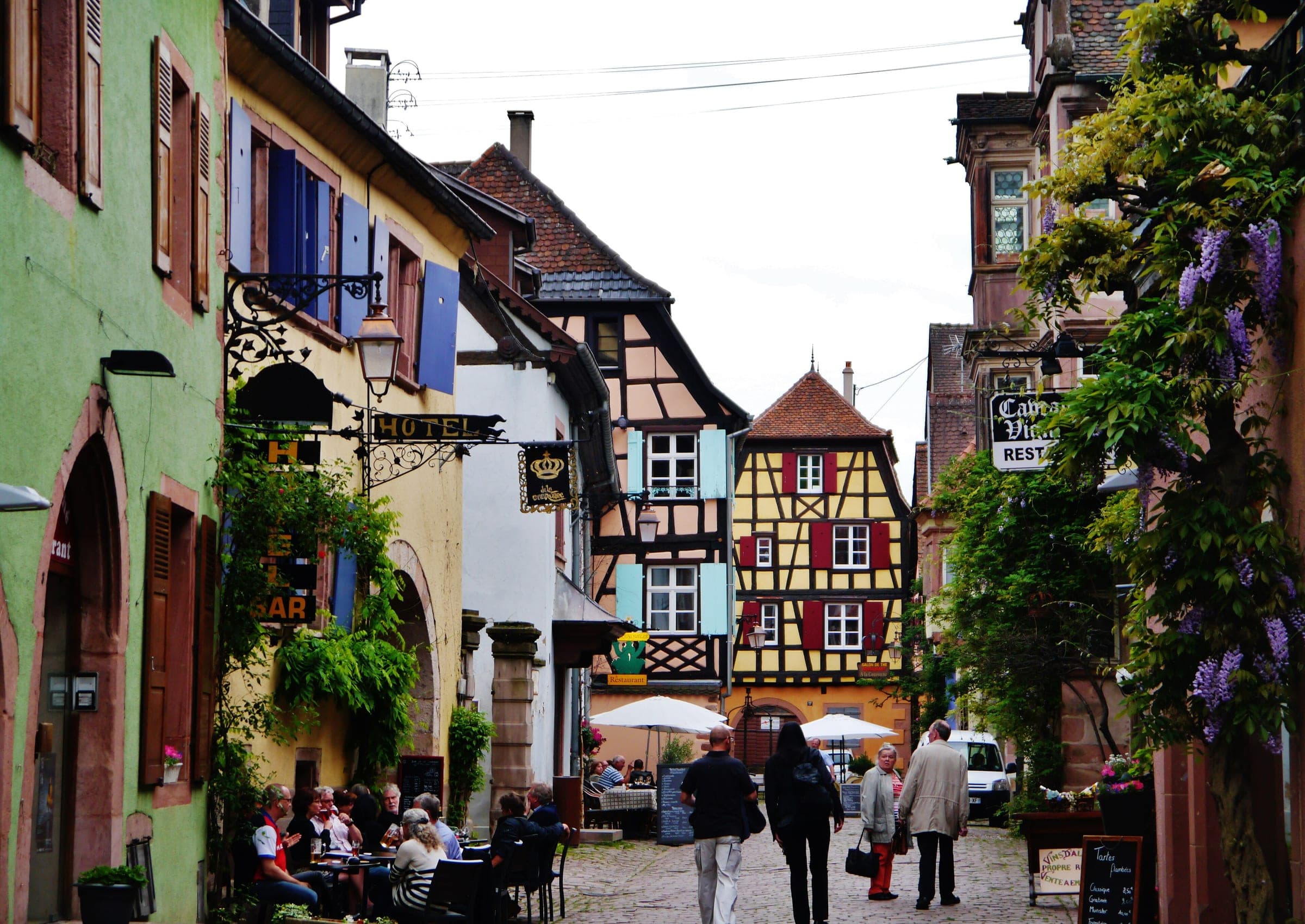 Colourful half-timbered houses line a cobbled street in the old town of Riquewihr.