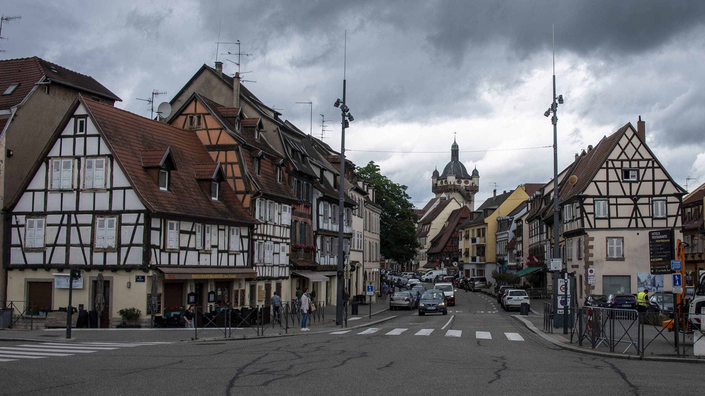 A street of half-timbered houses in Sélestat leads toward the Tour de l'Horloge.