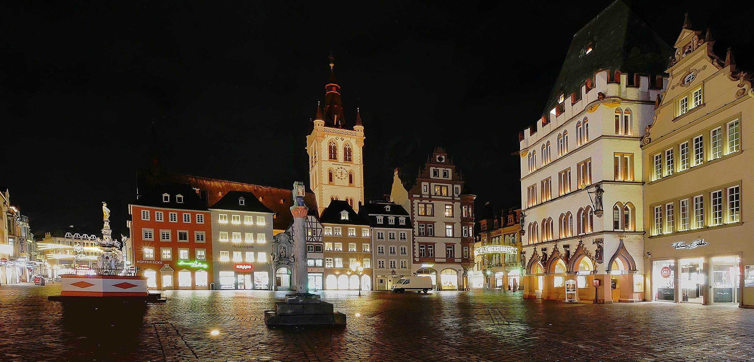 St Gangolf's tower rises over Trier's empty Hauptmarkt on a wet night