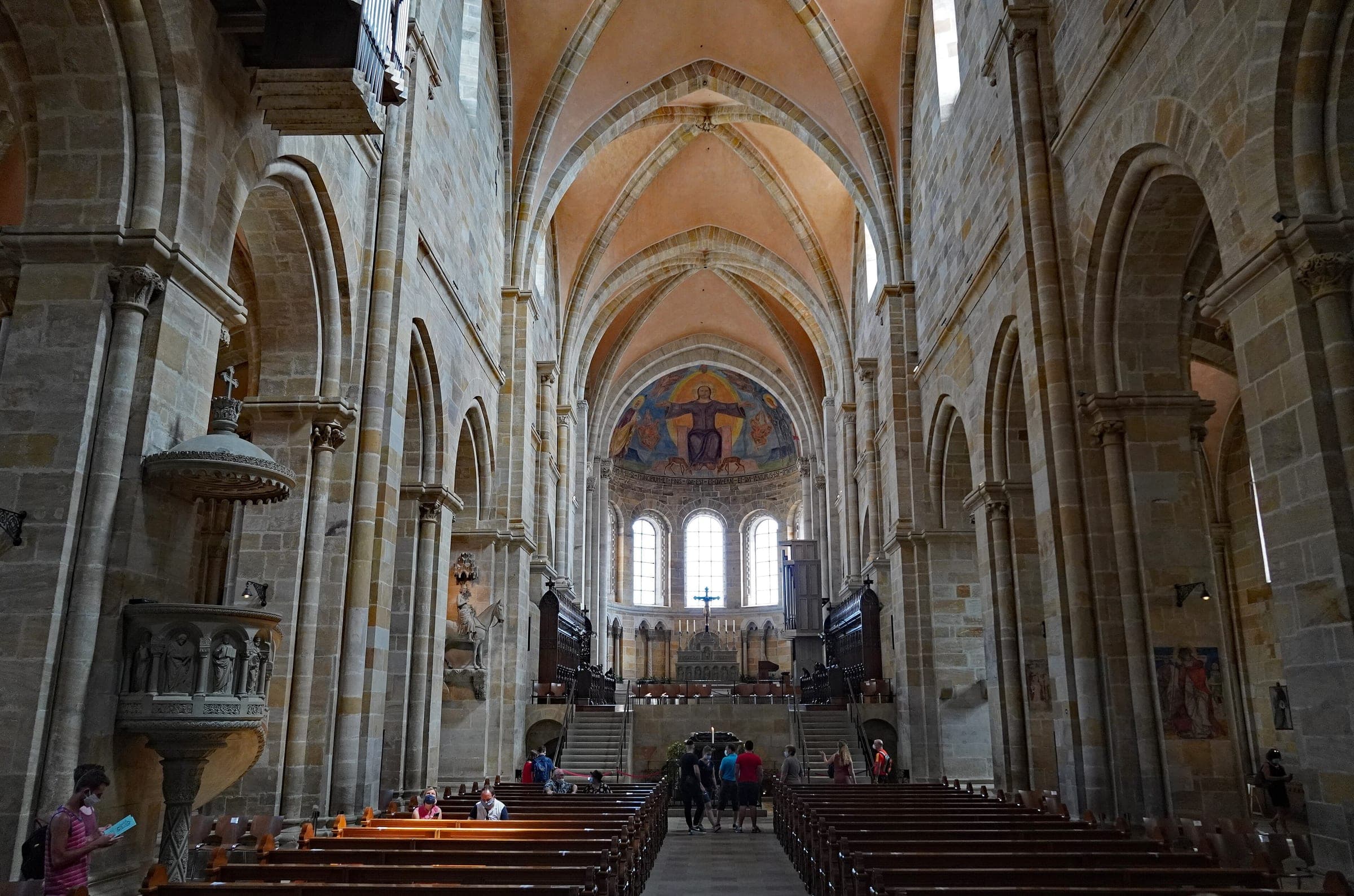 Round arches line the sandstone nave of Bamberg Cathedral up to a choir with a painted vault