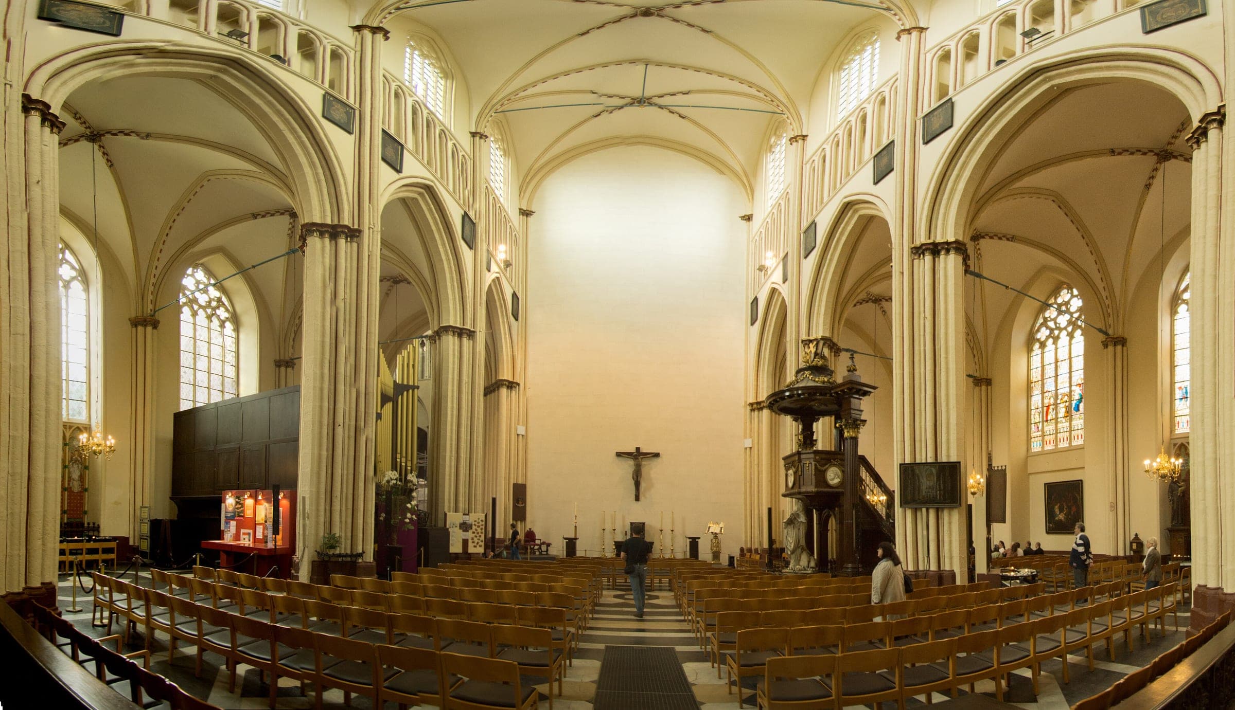 Rows of chairs fill the pale Gothic nave of St Salvator's Cathedral in Bruges beside its carved wooden pulpit.