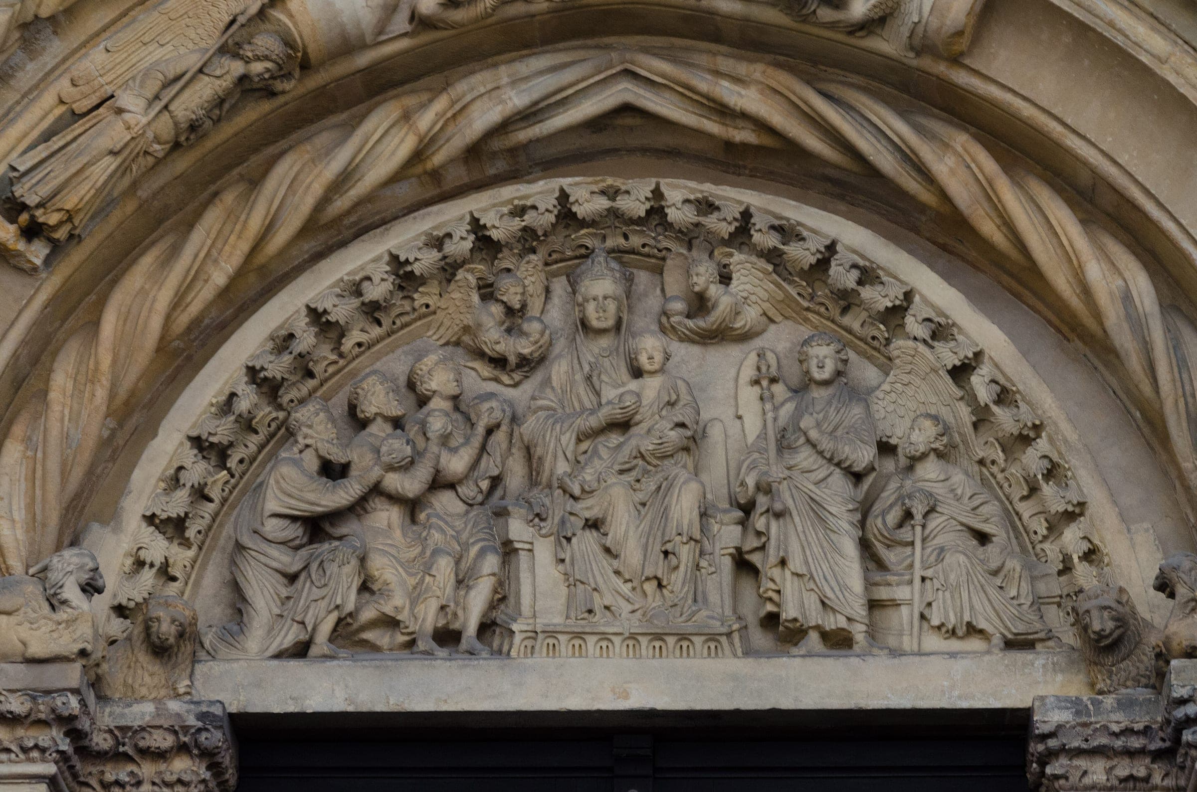Carved Romanesque figures crowd the tympanum of the Golden Gate at Freiberg Cathedral.