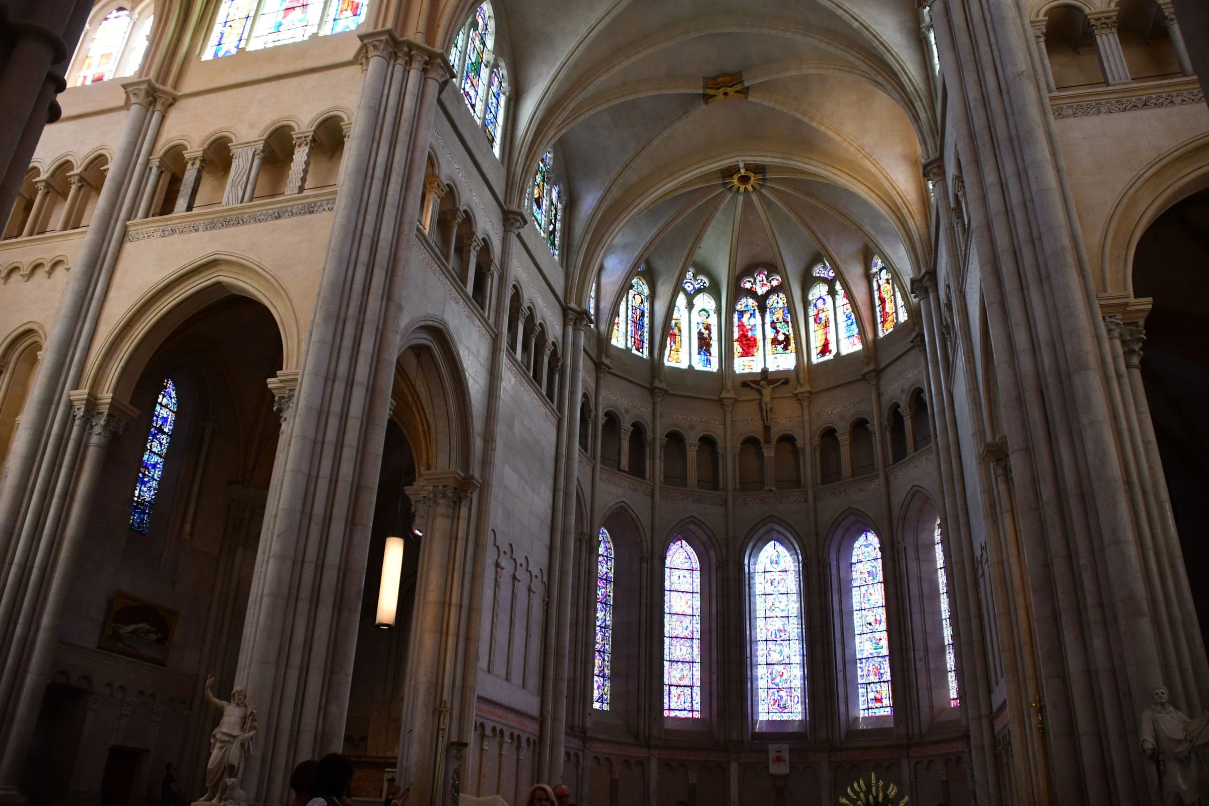 Medieval stained-glass windows ring the Gothic apse of Saint-Jean Cathedral in Lyon.