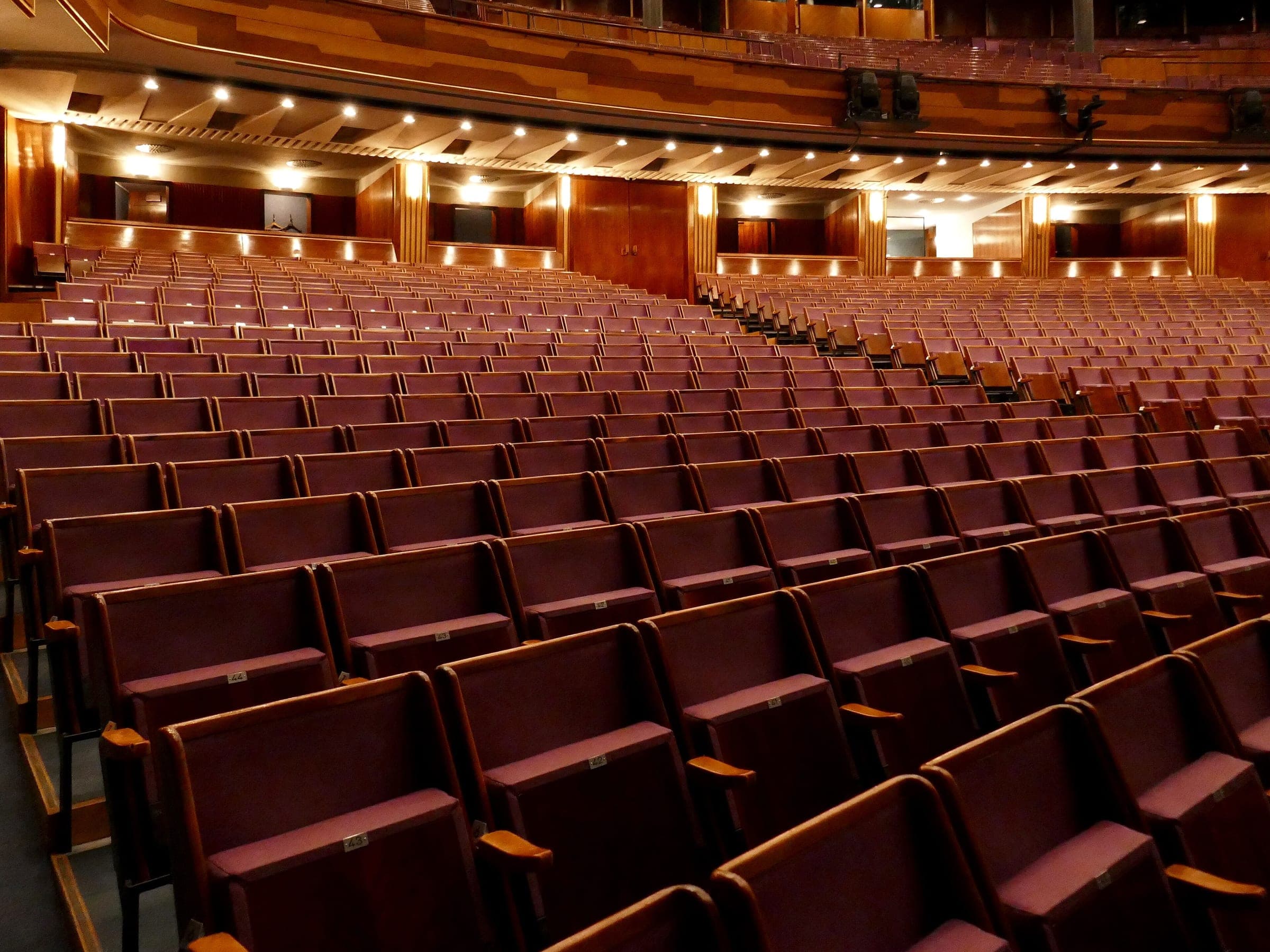 Rows of wooden seats sweep across the wide auditorium of the Grosses Festspielhaus in Salzburg